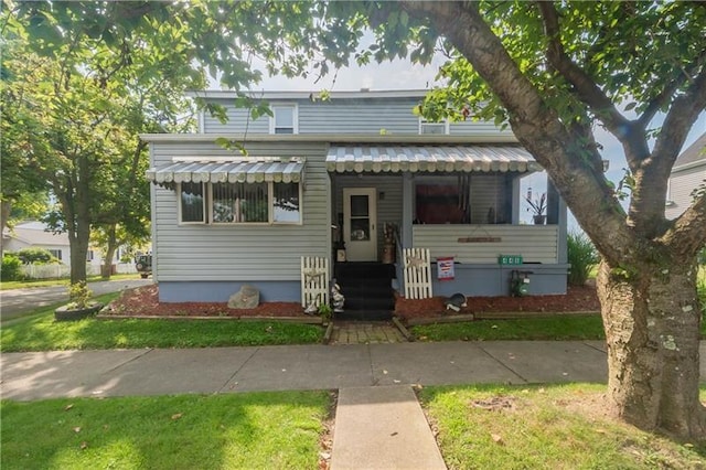 bungalow-style home with a front yard