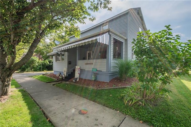 view of property exterior with a lawn