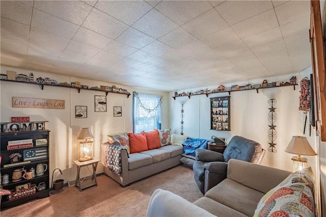 carpeted living room with a drop ceiling