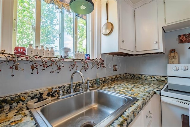 kitchen with white cabinets, white range with electric cooktop, and sink