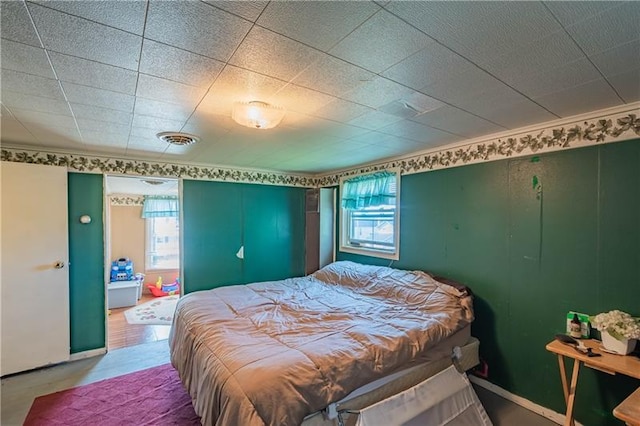 bedroom featuring crown molding and multiple windows