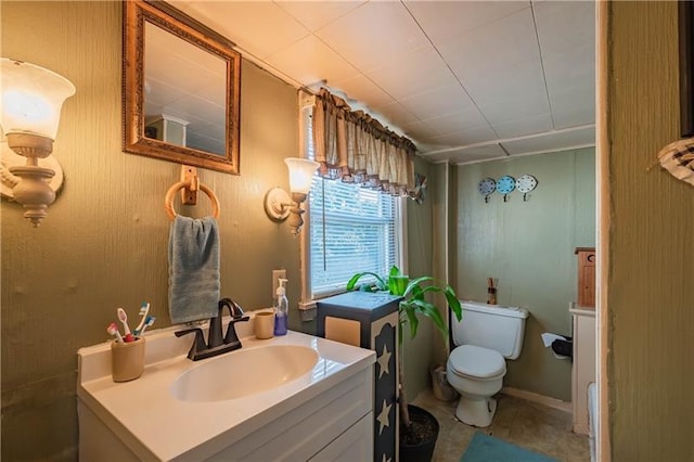 bathroom with tile floors, toilet, and vanity