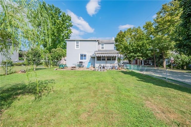 rear view of house with a yard