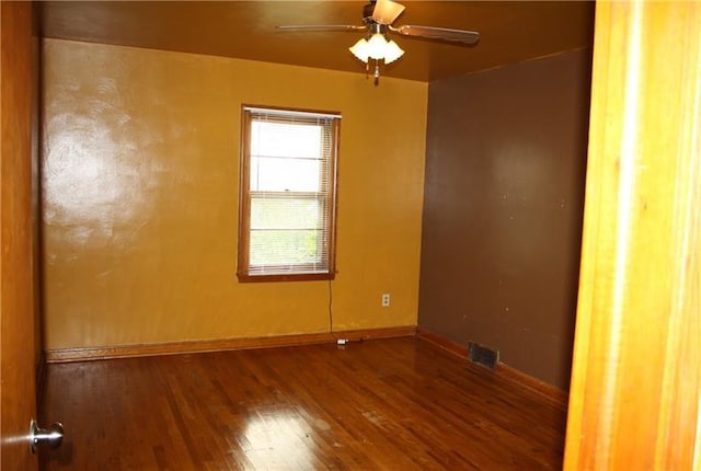 unfurnished room featuring ceiling fan and dark wood-type flooring