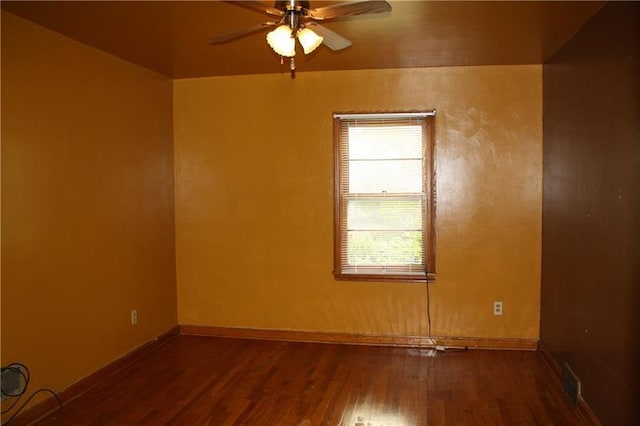 empty room with ceiling fan and dark wood-type flooring