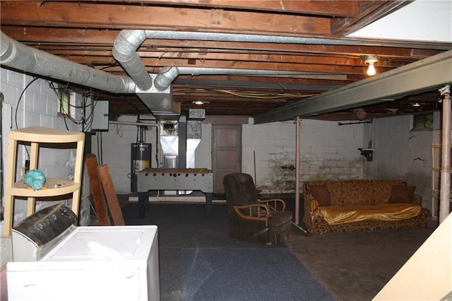 basement featuring water heater and separate washer and dryer