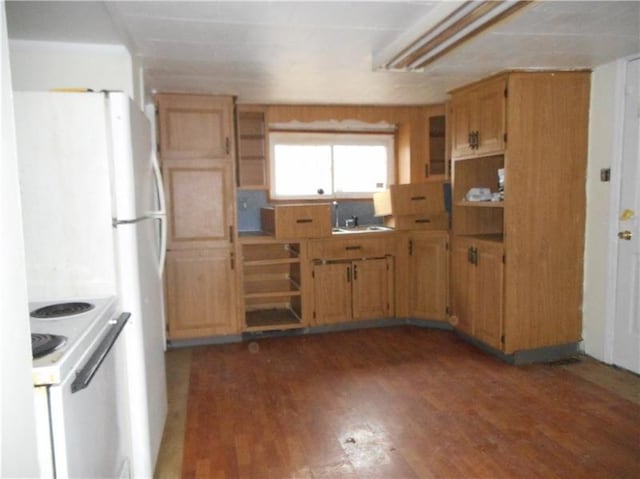 kitchen with stove, dark wood-type flooring, white refrigerator, and sink