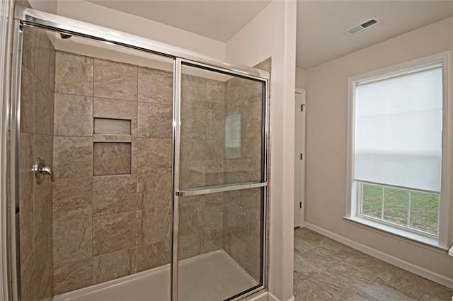 bathroom featuring an enclosed shower and tile flooring