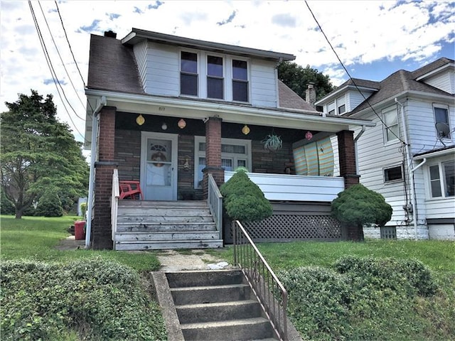 bungalow-style home with a porch and a front yard