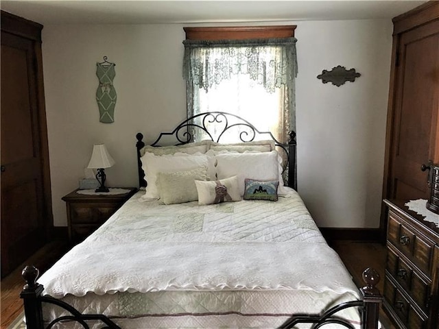 bedroom with dark wood-type flooring