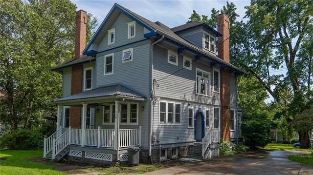 rear view of property with a porch