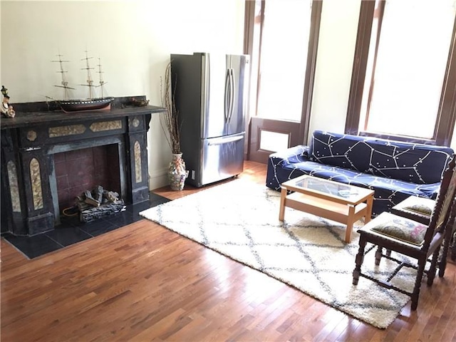 living room featuring dark hardwood / wood-style flooring and a tile fireplace