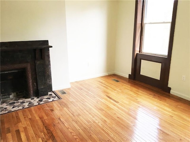 unfurnished living room featuring light hardwood / wood-style flooring