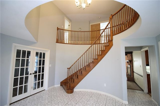 stairway with light tile floors, a high ceiling, and french doors