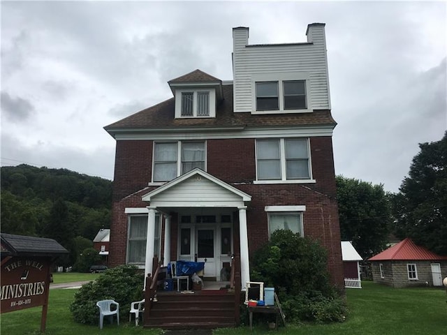 view of front of home featuring a front yard and a porch