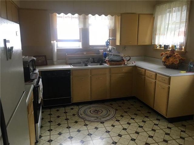 kitchen featuring sink, black dishwasher, range with electric stovetop, and stainless steel fridge