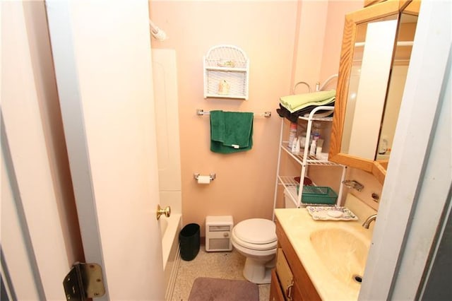 bathroom with toilet, tile floors, and vanity with extensive cabinet space