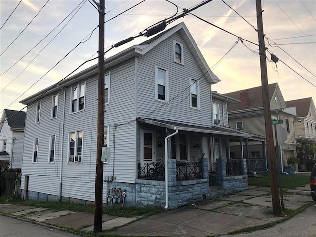 property exterior at dusk with covered porch