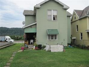 rear view of property with a yard