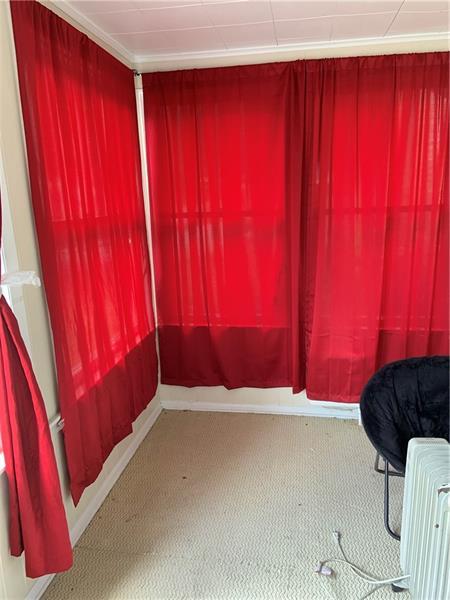 carpeted spare room featuring radiator