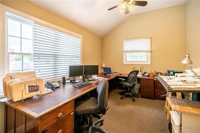 office space with vaulted ceiling, ceiling fan, dark colored carpet, and a wealth of natural light