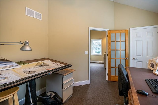 home office with dark carpet and vaulted ceiling