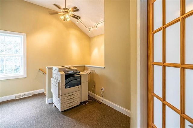 interior space featuring ceiling fan, dark colored carpet, and rail lighting