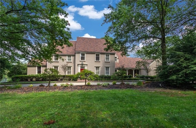 colonial-style house with a front lawn