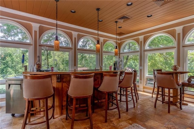 bar featuring light tile flooring, decorative light fixtures, and wooden ceiling