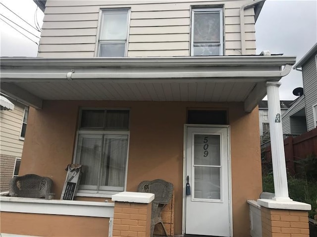 view of exterior entry with a porch