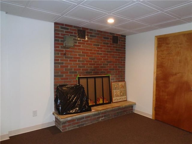 unfurnished living room with brick wall and a brick fireplace