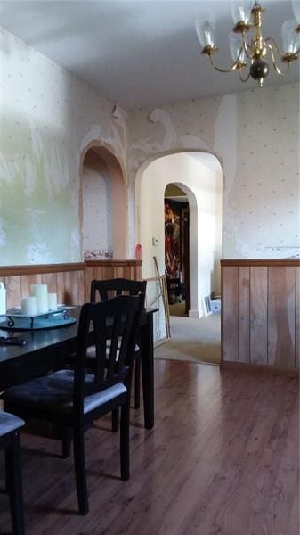 dining space featuring a notable chandelier and dark wood-type flooring