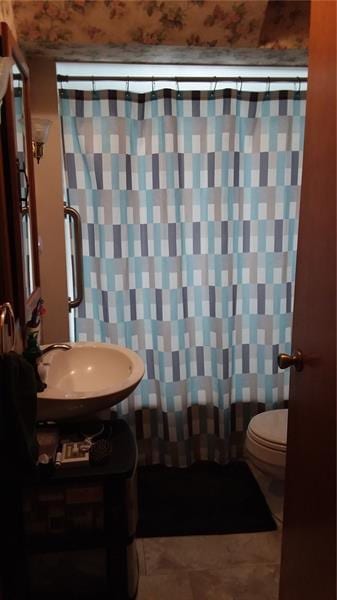 bathroom with tile flooring, sink, and toilet