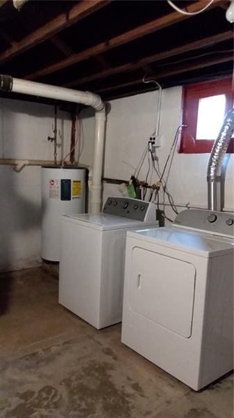 clothes washing area with washing machine and clothes dryer and electric water heater