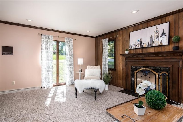 living area featuring wooden walls, a healthy amount of sunlight, and light colored carpet