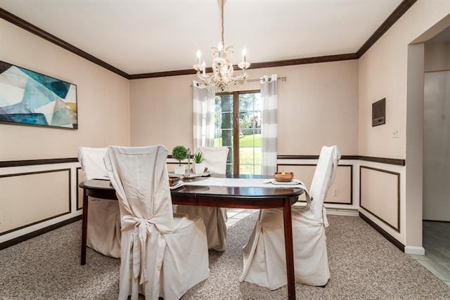 carpeted dining space featuring crown molding and an inviting chandelier