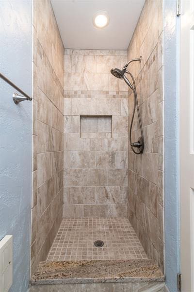 bathroom with tiled shower