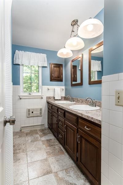 bathroom with double sink vanity, tile walls, and tile flooring