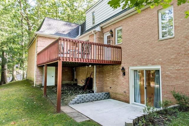 back of house featuring a deck, a yard, and a patio area