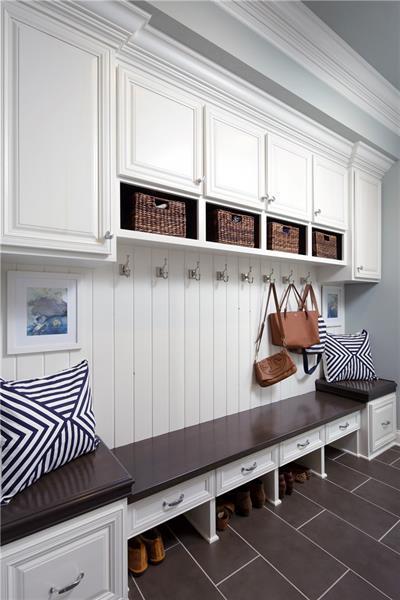 mudroom with dark tile flooring and ornamental molding