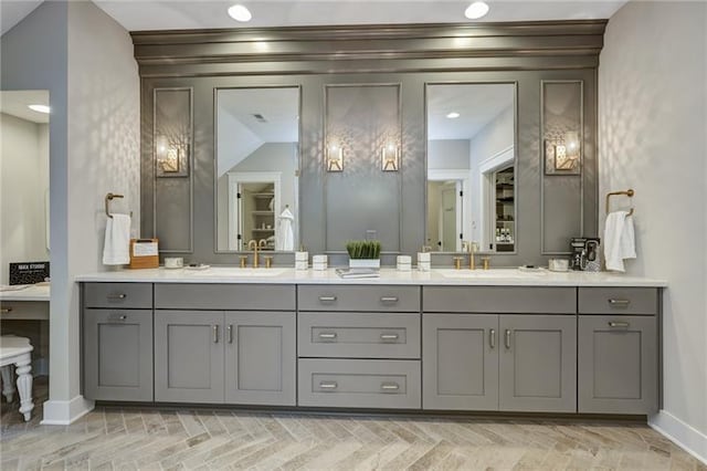 bathroom with vaulted ceiling and dual vanity