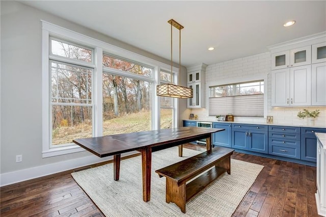 dining space featuring dark hardwood / wood-style flooring and a healthy amount of sunlight