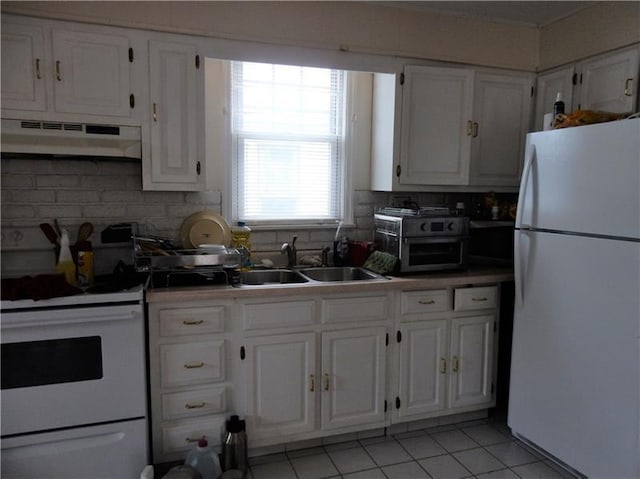 kitchen with white appliances, sink, tasteful backsplash, and white cabinetry