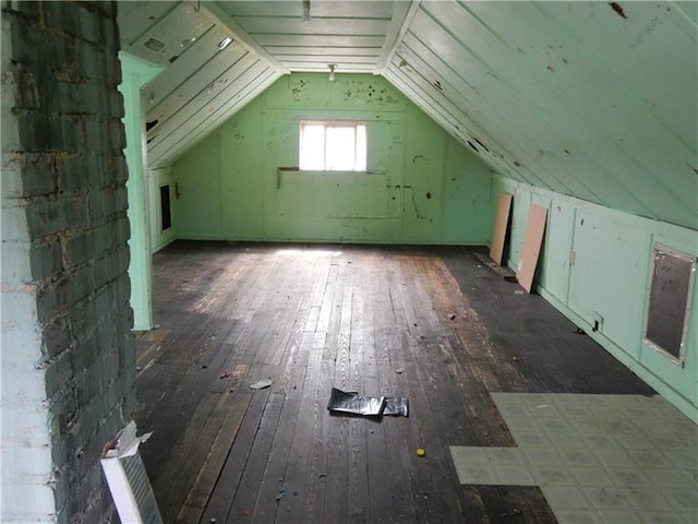 additional living space with lofted ceiling and dark wood-type flooring