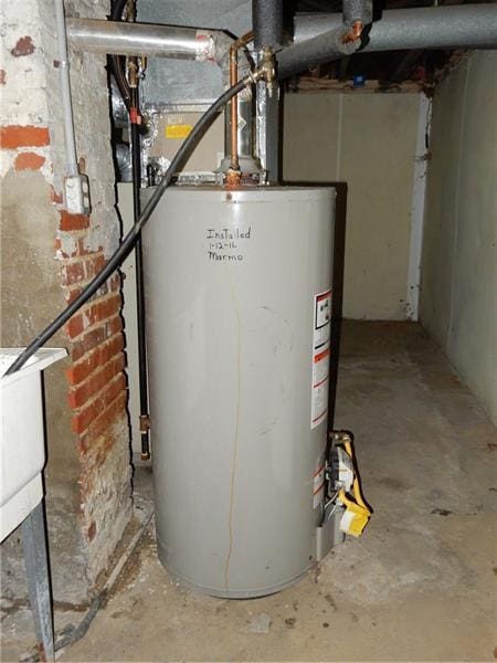 utility room featuring gas water heater