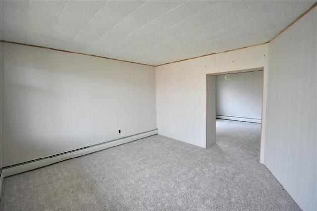 carpeted empty room with baseboard heating