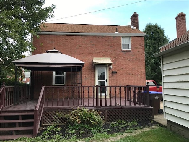 back of house with a wooden deck and a gazebo