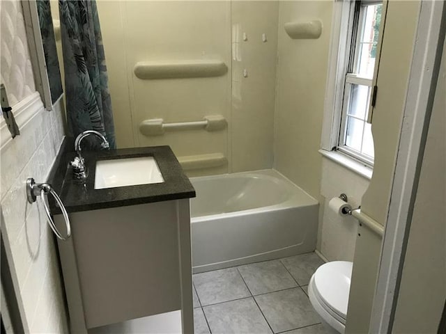 full bathroom with tile floors, large vanity, bathtub / shower combination, and toilet