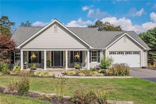 view of front of house with a porch, a front yard, and a garage