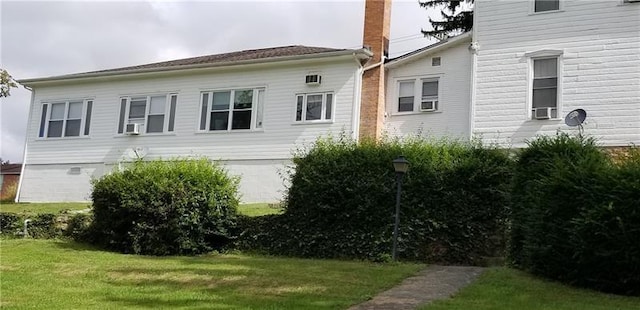 view of home's exterior with a lawn